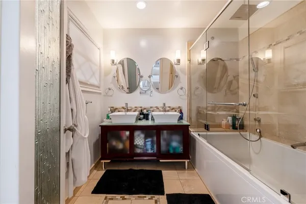 a bathroom with a bathtub a sink and a shower