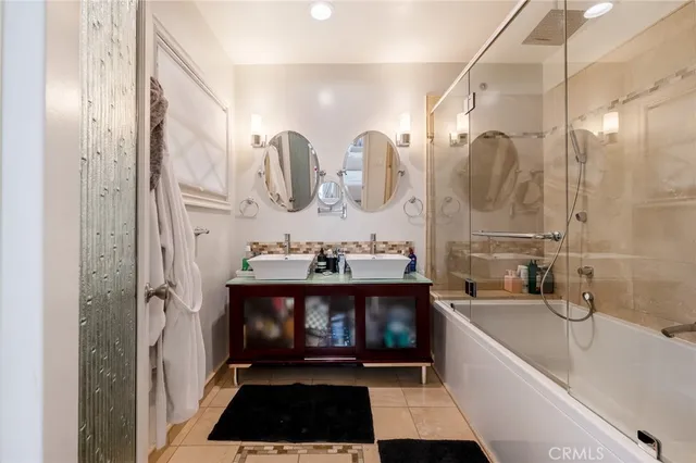 a bathroom with a bathtub a sink and a shower