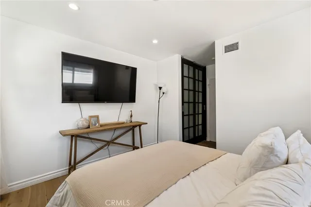 a bedroom with a bed and a flat screen tv