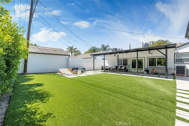 a view of a house with pool and chairs