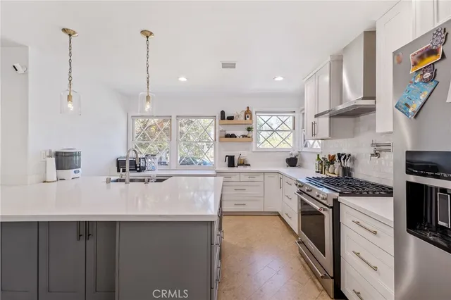 a kitchen with appliances a sink and cabinets