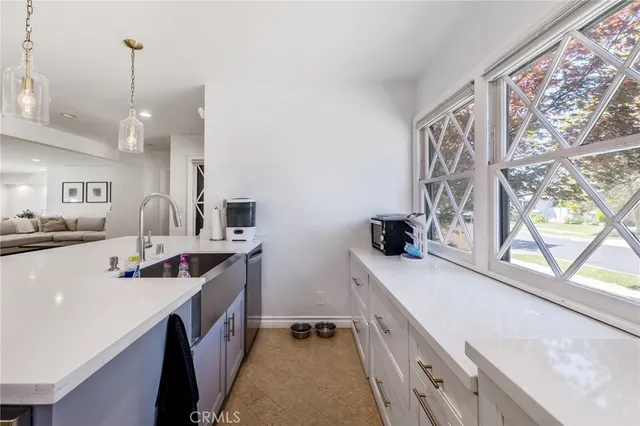 a kitchen with stainless steel appliances a sink stove and cabinets