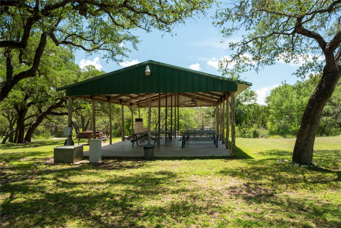 Lot 176 Suncrest Trail Bertram, TX 78605 - Photo 29 of 31 a view of swimming pool with a table and chairs under an umbrella