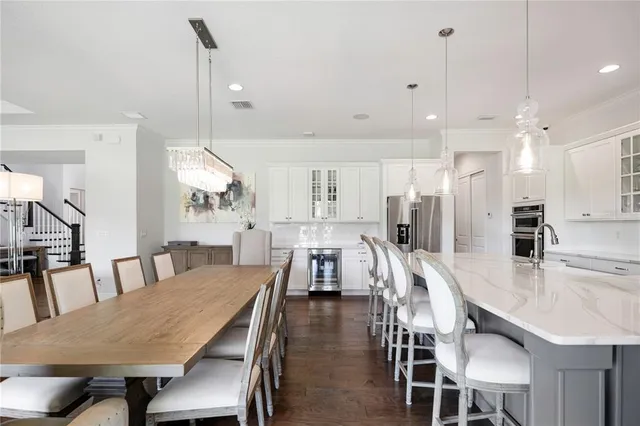 a kitchen with stainless steel appliances granite countertop a sink a counter space and cabinets