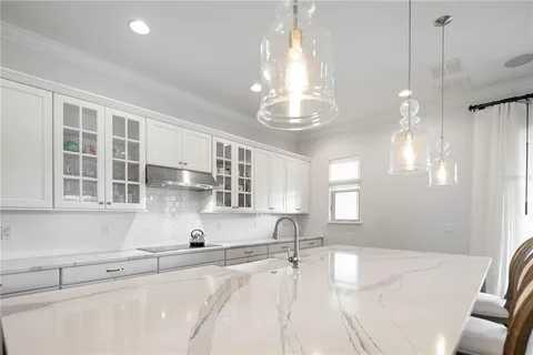 an aerial view of a city with lots of residential buildings and mountain view in back