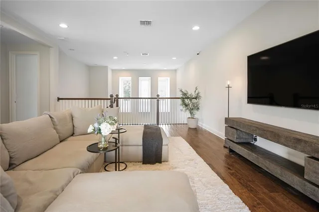 an aerial view of a house with a yard and large trees