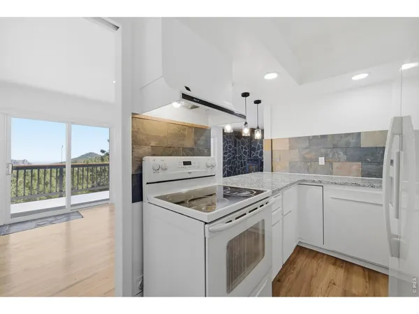 a kitchen that has a sink a stove and a microwave