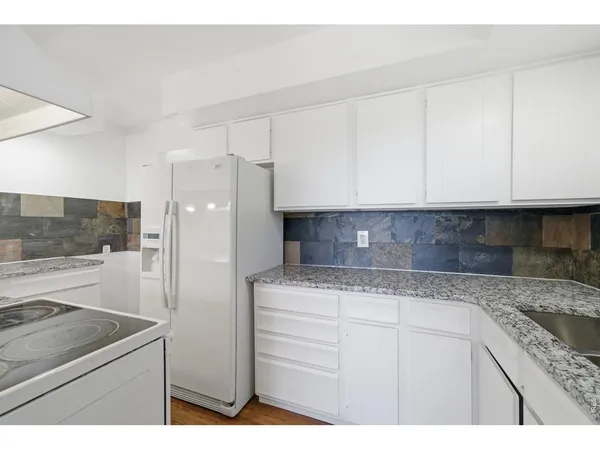 a kitchen with cabinets appliances and a counter space