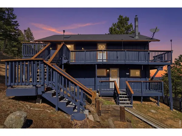 a view of a house with pool and deck