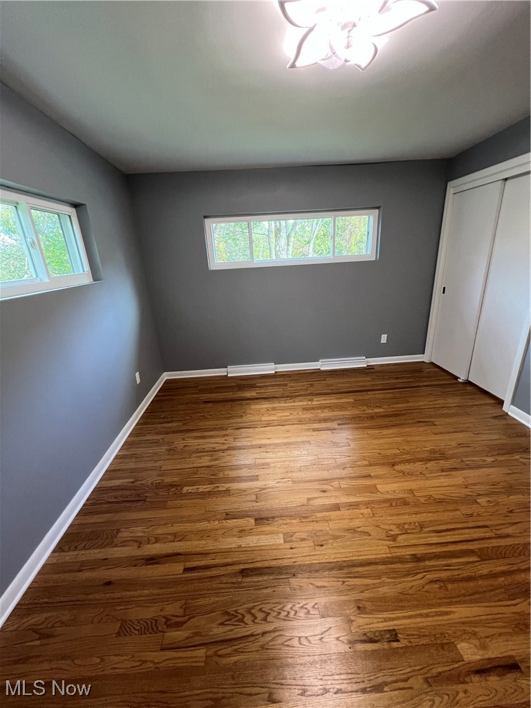 815 Sugar Road Akron, OH 44321 - Photo 13 of 22 Bedroom 2 with hardwood floors, roomy closet, and fandalier.