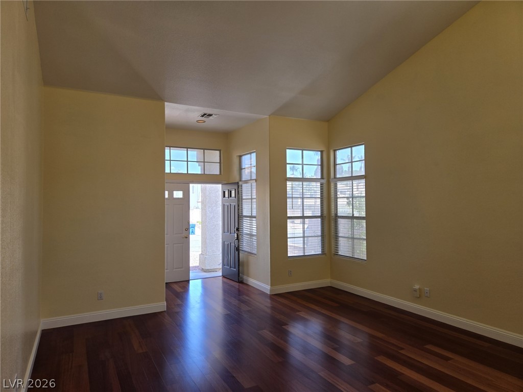 8417 San Ramon Drive Las Vegas, NV 89147 - Photo 7 of 33 Rich hardwood floors welcome you into this sun-drenched living space featuring vaulted ceilings and ample natural light.