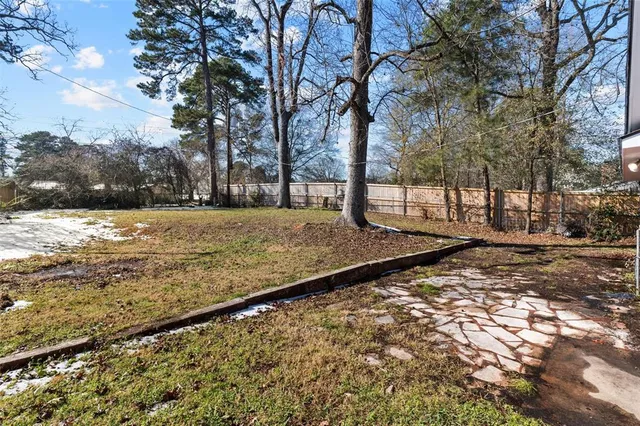 a view of a yard with a tree