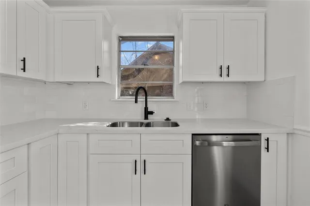 a kitchen with a sink and cabinets