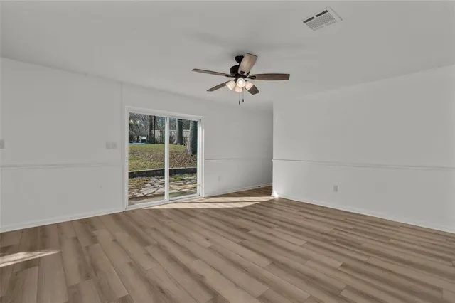 wooden floor in an empty room with a window