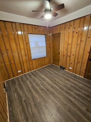 a view of a room with wooden walls