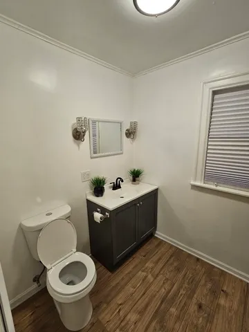 a bathroom with a sink mirror vanity and toilet
