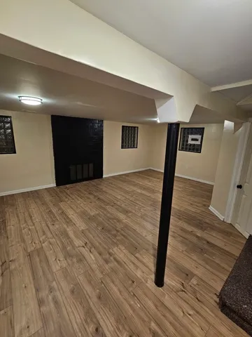 a view of a livingroom with wooden floor and stairs