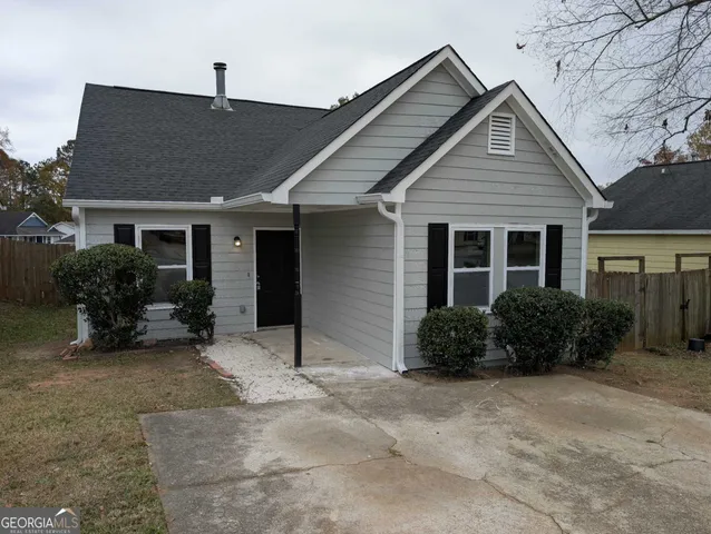 a view of a house with a yard and plants