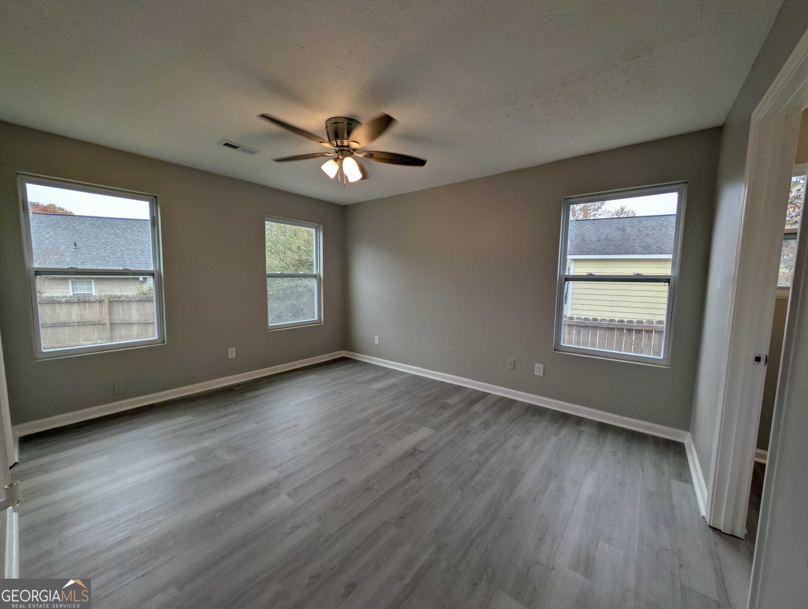 128 Crystal Brook Griffin, GA 30223 - Photo 13 of 25 a view of an empty room with a window and wooden floor