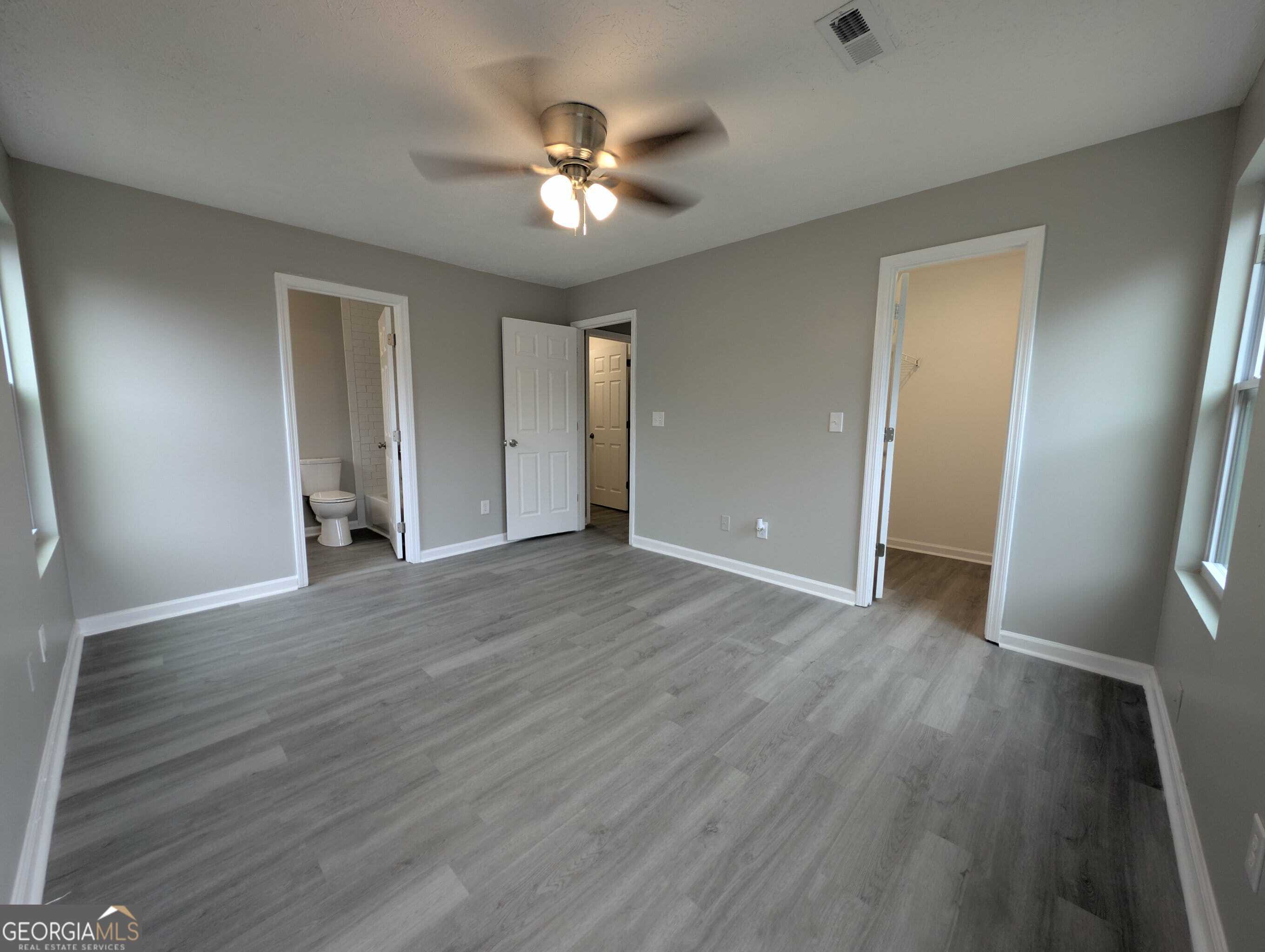 128 Crystal Brook Griffin, GA 30223 - Photo 14 of 25 a view of an empty room with wooden floor and a window