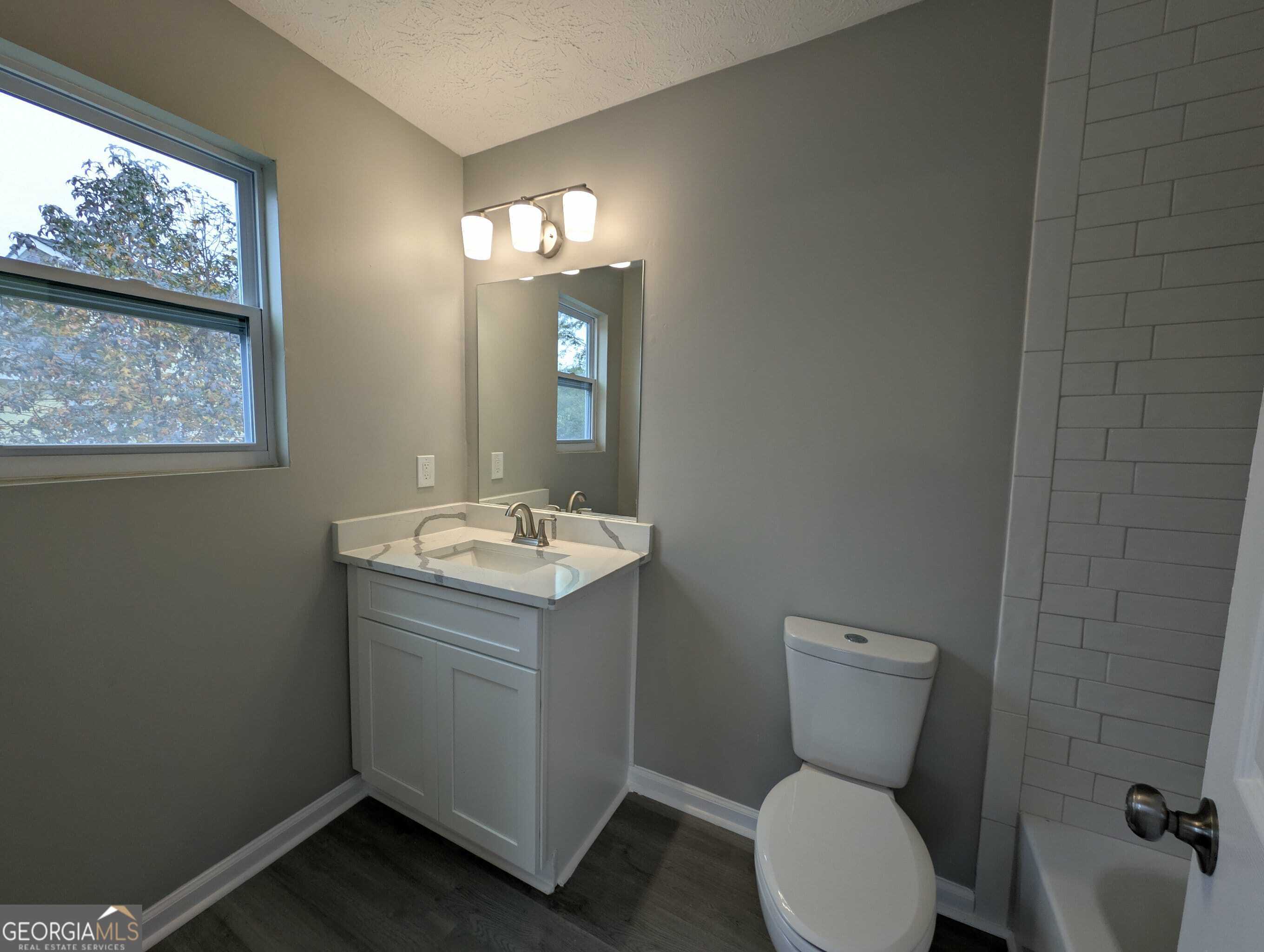 128 Crystal Brook Griffin, GA 30223 - Photo 17 of 25 a bathroom with a toilet sink and mirror