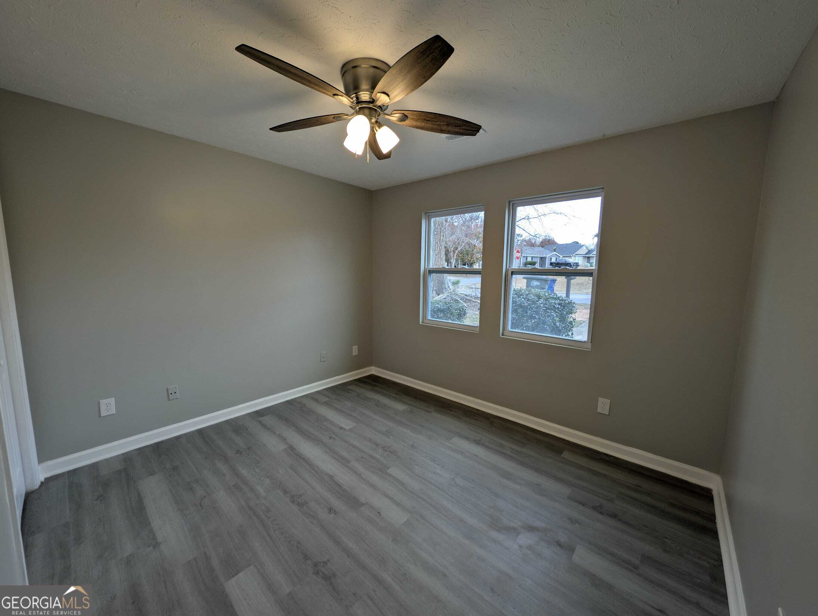 128 Crystal Brook Griffin, GA 30223 - Photo 19 of 25 a view of an empty room with a window and wooden floor
