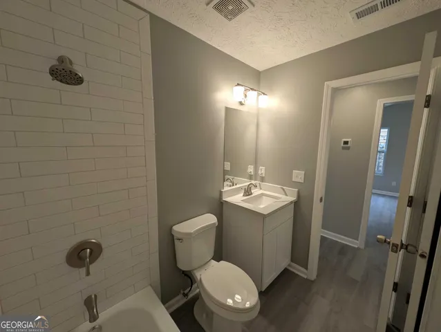 a bathroom with a toilet a sink and shower