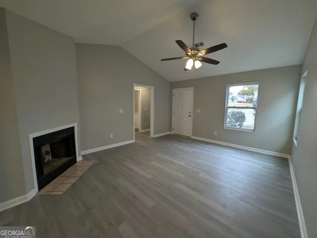a view of an empty room with a fireplace