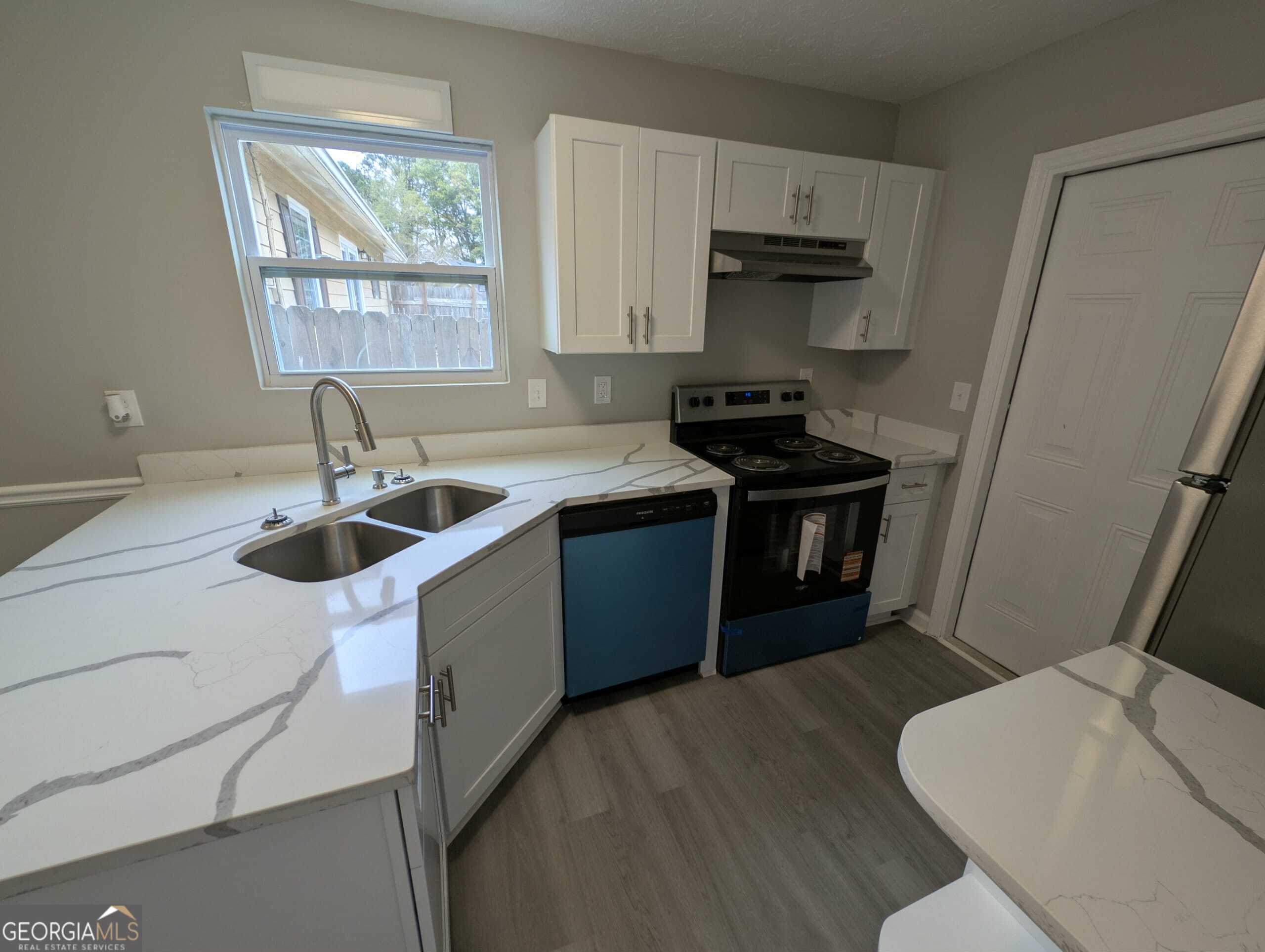 128 Crystal Brook Griffin, GA 30223 - Photo 7 of 25 a kitchen with a sink stove and cabinets