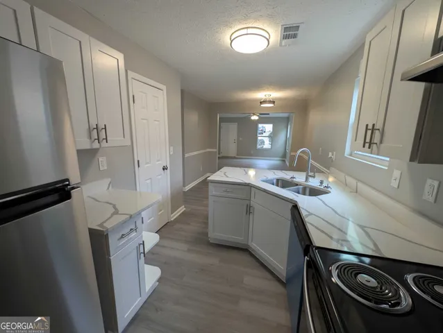 a room with a sink a washer and dryer