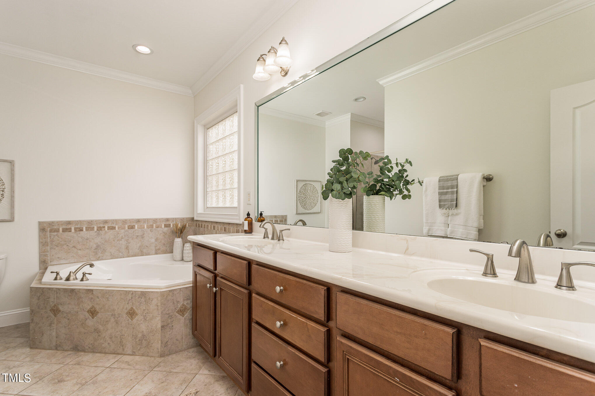 612 New Road Raleigh, NC 27608 - Photo 6 of 12 a bathroom with a tub sink and mirror