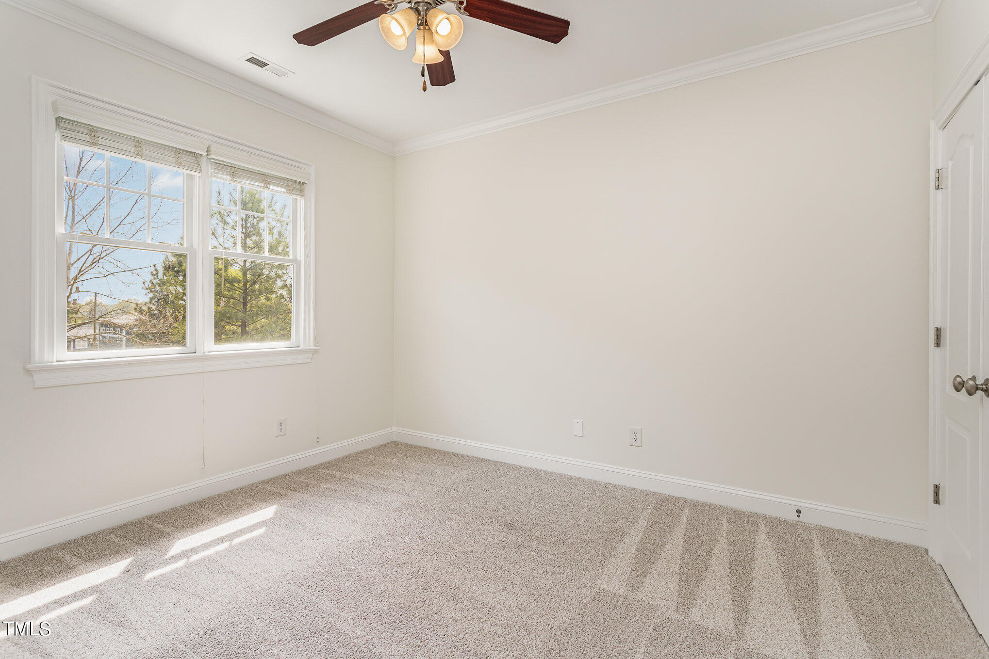 612 New Road Raleigh, NC 27608 - Photo 8 of 12 an empty room with a window and a fan