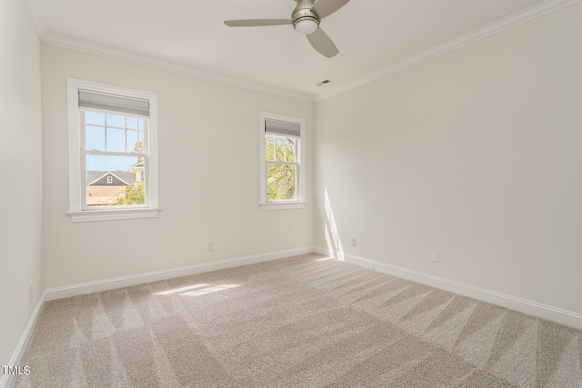 612 New Road Raleigh, NC 27608 - Photo 9 of 12 an empty room with windows and fan