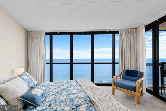 a bedroom with a bed and a dresser next to a window