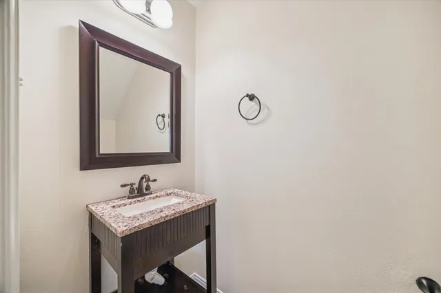 a bathroom with a sink vanity and a mirror