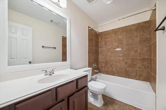a bathroom with a sink a toilet and bathtub