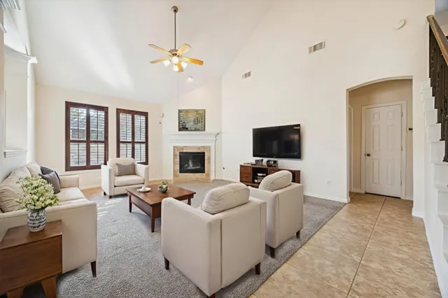 a living room with furniture a fireplace and a flat screen tv