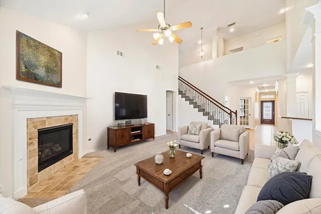 a living room with furniture fireplace and flat screen tv