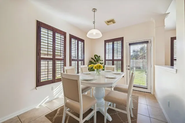 a view of a dining room with furniture wooden floor and chandelier