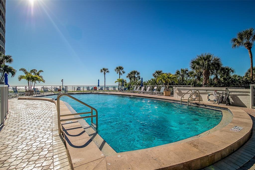 6300 Midnight Pass Road, Unit 21 Sarasota, FL 34242 - Photo 24 of 30 a view of a swimming pool with a lounge chair