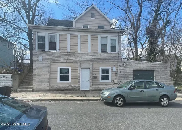 a car parked in front of a brick house