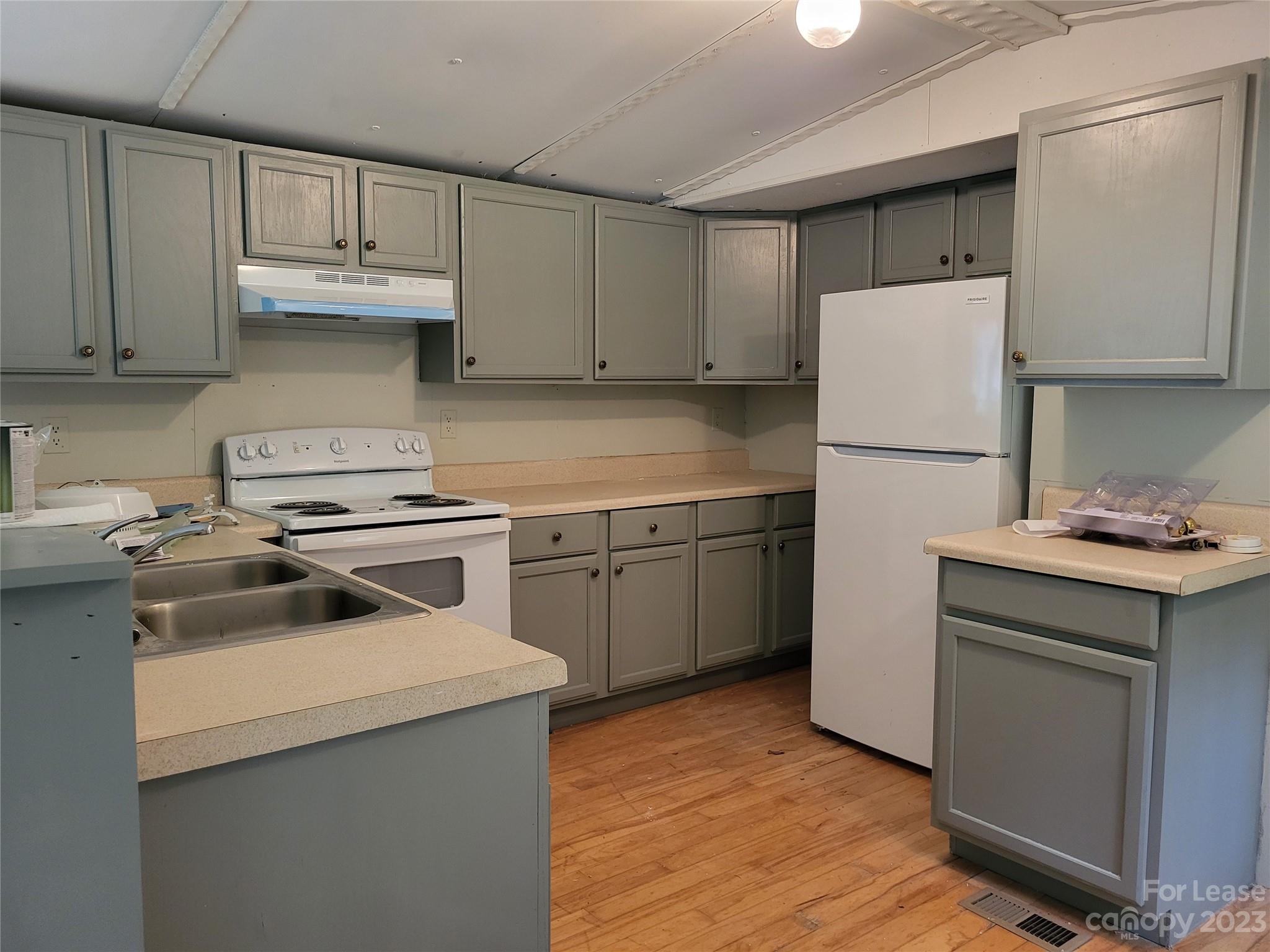 1158 Wagon Wheel Road, Unit 7 Hickory, NC 28602 - Photo 4 of 11 a kitchen with a sink a stove and refrigerator