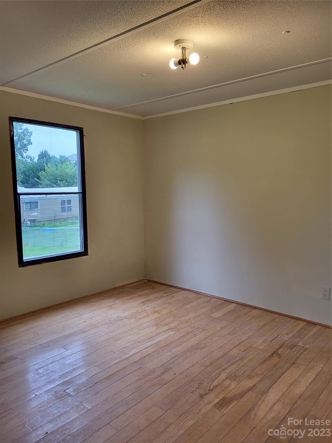 1158 Wagon Wheel Road, Unit 7 Hickory, NC 28602 - Photo 6 of 11 an empty room with wooden floor and windows
