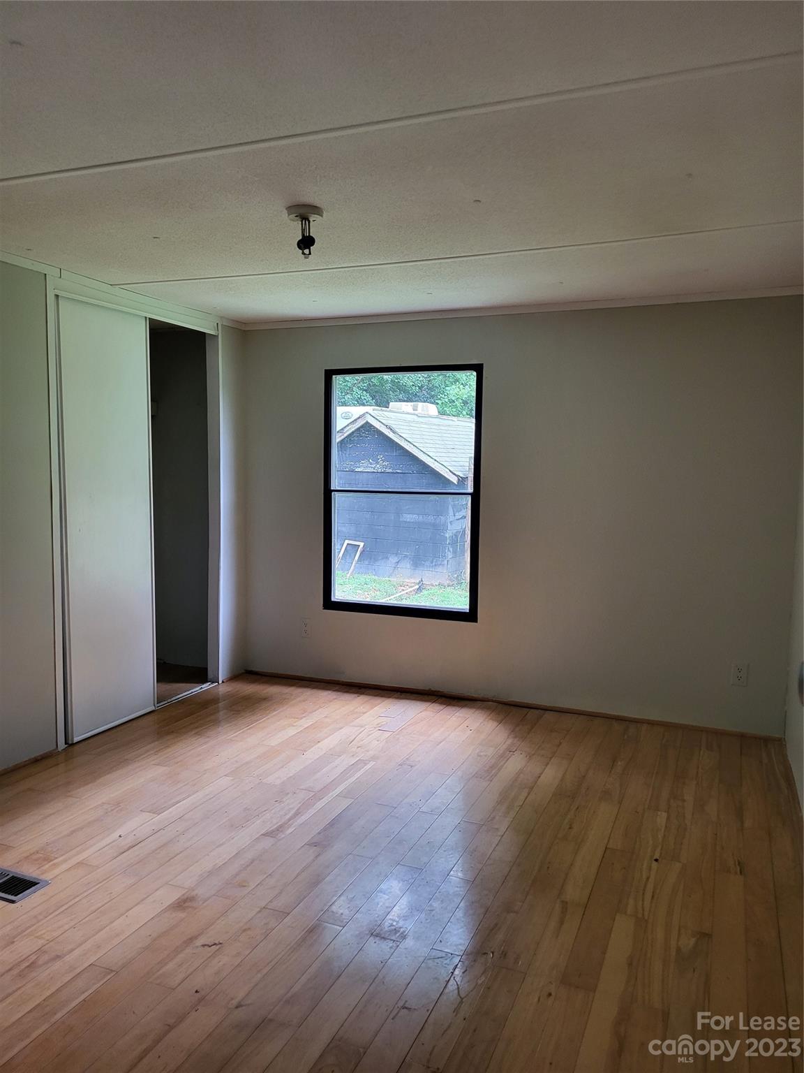 1158 Wagon Wheel Road, Unit 7 Hickory, NC 28602 - Photo 8 of 11 an empty room with wooden floor and windows