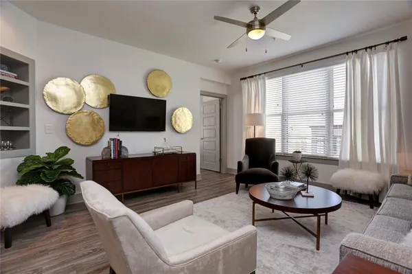a living room with furniture chandelier and a large window