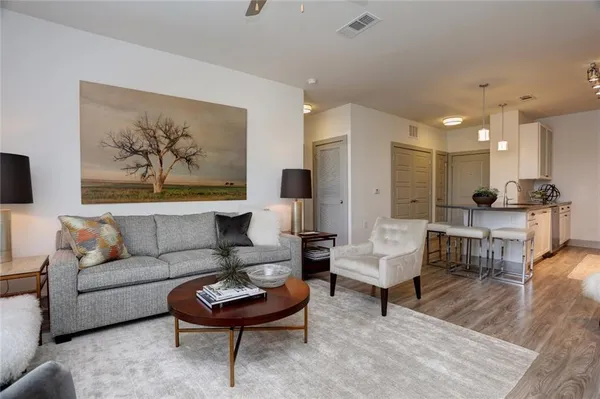 a living room with furniture and a painting