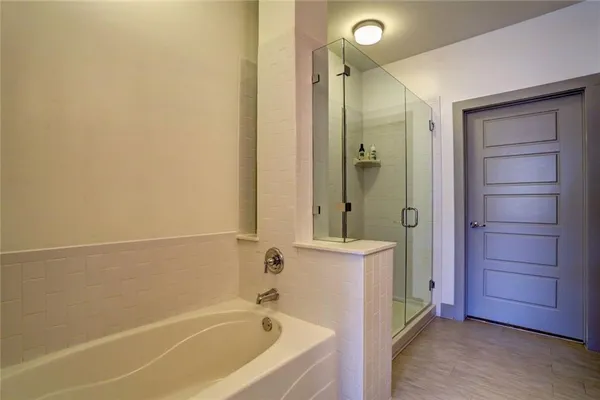 a bathroom with a bathtub and a shower