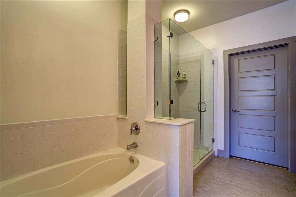 1213 Avalon Boulevard, Unit 44217 Alpharetta, GA 30009 - Photo 20 of 27 a bathroom with a bathtub and a shower