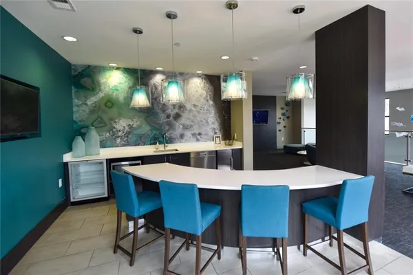 a large kitchen with a table and chairs