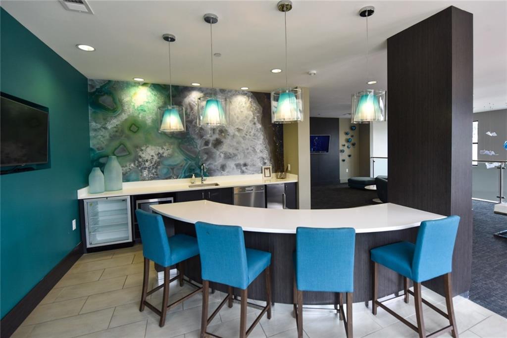 1213 Avalon Boulevard, Unit 44217 Alpharetta, GA 30009 - Photo 25 of 27 a large kitchen with a table and chairs